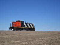 A scene that forever belongs to the past. The crew had brought 1432 to a stop so I could get a virtually unobstructed photo in one of the countless fields that hug the track. Im not sure if theres anything else on this planet that would scream Saskatchewan than a GMD-1 silhouetted against an open sky. The provinces catch phrase, land of the living sky, seems to hold true.

Ticks always seem to find a way, with grass and dry shrubs sparse and no higher than ankle high, they always seem to exist in the weirdest, most secluded places. But then again, where deer exist and graze, so do they. Thankfully, caught the culprit before it could get a bite. 
