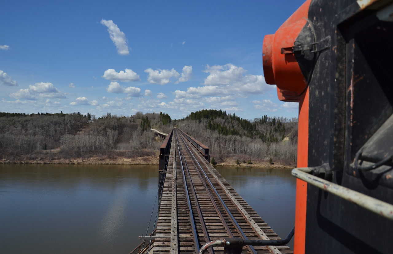 On the pilot looking West is quite a site.

This river, culminates into one of the signature attractions on the line, the historic “ Crooked Bridge “ over the Saskatchewan River. Construction on the bridge began in 1928 and was completed in January of 1930. 

What the bridge is most synonymous and recognized for, is the uncommon double deck girder plate design, incorporating a 16ft roadway directly under the upper railway deck. This is a similar design to the Fraser River bridge in New Westminster, B.C. for comparison. The bridges total length sits at 1,906ft, making it one of the largest steel bridges in Western Canada.