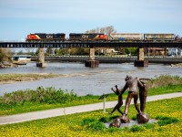 AC Traction power, a not too common sight on the Mont-Joli subdivision, pulls train 403 over the Rimouski river. In the foreground, we can see one of Roger Langevin's sculptures.