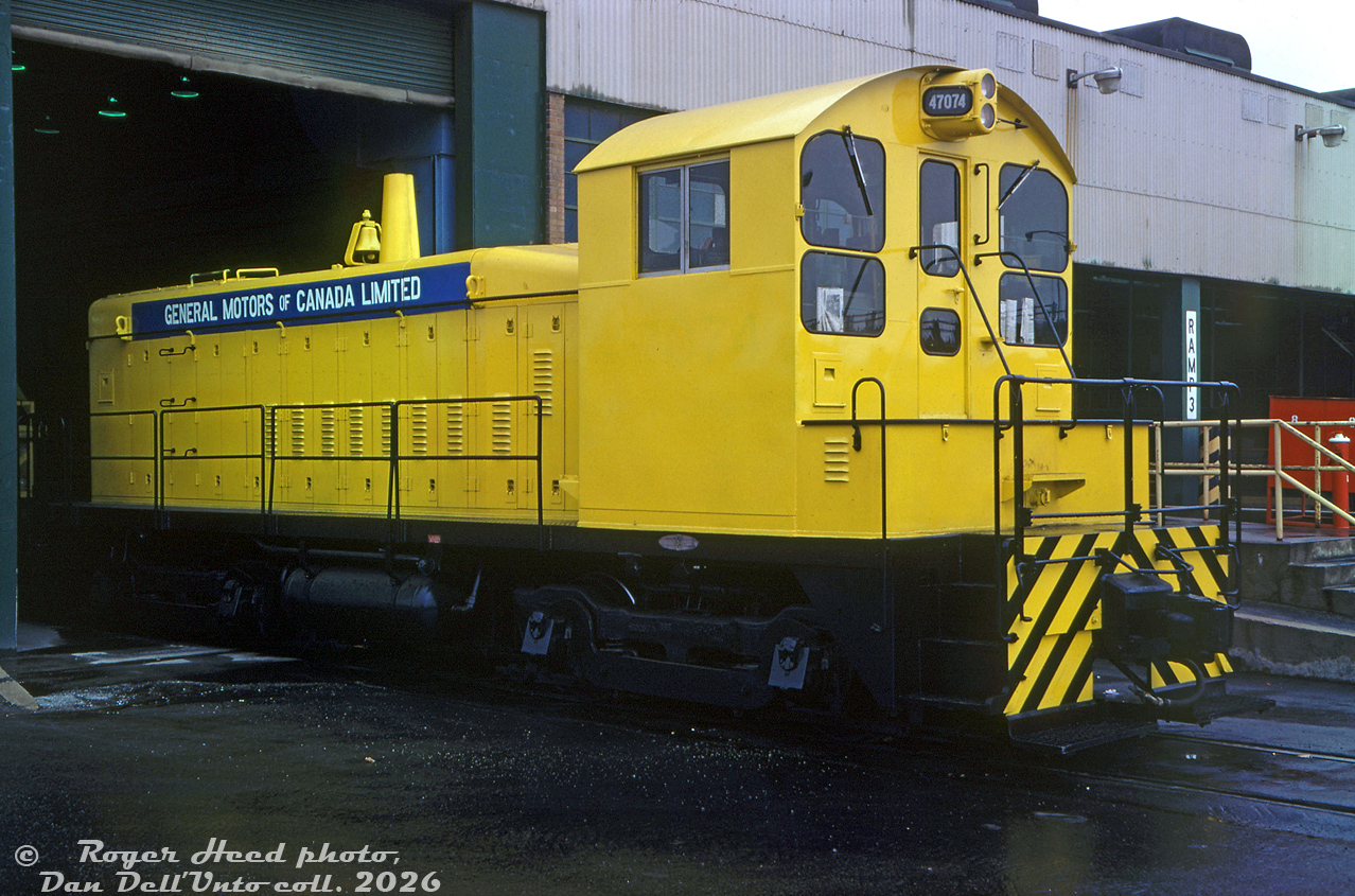 General Motors of Canada Ltd SW900 47074 sits inside the grounds of GM's former McKinnon Industries St. Catharines plant (foundry/casting work), looking clean and near spotless on this wet day. This yellow switcher was originally built by GMD London in 1966 for McKinnon Industries, later acquired by GM of Canada. It was eventually sold to Dofasco in Hamilton and became their 416.The 900hp single stack SW900 model, powered by an 8-cylinder 567C, was part of EMD/GMD's common switcher platform line at the time and was in the middle range of their product offering: less powerful than the 12 cylinder 1200hp SW9/SW1200 model, but more powerful than the 6-cylinder 600hp SW1/SW600. It (and its 800hp predecessor SW8) were popular for light switching and industrial use.Roger Heed photo, Dan Dell'Unto collection slide.