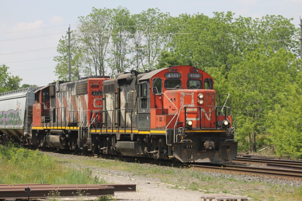 CN 4141 leads the local after holding at Lihou for an eastbound to run ahead of it.