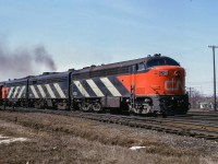 After making <a href=https://www.railpictures.ca/?attachment_id=55278>their station stop,</a> train 50, the Lakeshore, departs Belleville for points east.

Scan and editing by Jacob Patterson.