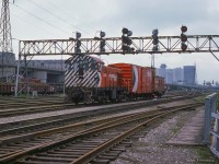 CP 7020 makes its way through Toronto Terminals Railway trackage at Cherry Street with a single box car and van, while another small ALCO/MLW switcher can be seen to the south of the main near Don yard.  Built in 1944, CP 7020 remains <a href=https://www.railpictures.ca/?attachment_id=58934>on display at the former John Street roundhouse.</a>

<br><br><i>Scan and editing by Jacob Patterson.</i>