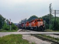 Three SD40-2s rumble through Bala with a northbound freight, passing over the south siding switch and the Gordon Street crossing.

<br><br><i>Scan and editing by Jacob Patterson.</i>
