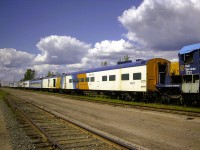 <b> Passenger train to nowhere </b> <br>
A plethora of retired passenger cars sit on a deadline in ONR's North Bay, ON yard on May 4, 2004. <br>
ONR equipment in the lineup originated from many different roads such as CN, CP, GO Transit, L&N, N&W, and VIA Rail. <br>
Coupled to the nose of ONT 1732 is ONT 1407 Moose River. This car was built by Pullman Standard in July 1954 for CN as their CN 908 Luster Lake, Class PC-79-A Buffet Parlor car. It was transferred from CN to VIA in March 1978 and was sold to ONR in 1986.