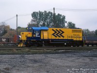 A brand new GMD GP38-2 in flashy blue and yellow chevron paint brightens up a gloomy day down at CP's Quebec Street yard in London: Ontario Northland 1808, freshly outshopped from the nearby GMD London plant, sits awaiting forwarding to its owner in northern Ontario. It was part of a two unit order built in 1984 (units 1808-1809), numbered above ONR's existing eight units 1800-1807. These two were later production units featuring Q-fans, corrugated radiator grills, and angled "laundry chute" blower housings, on top of most of the usual "Canadian" spotting features such as nose headlight, tri-colour class lights, numberboard-mounted bell, vertical Canadian steps/handrails, and showshields behind the cab.<br><br><i>Gord Taylor photo, Dan Dell'Unto collection slide.</i>
