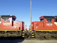 Face to Face. 4/14/16. CN SD60"s 5475/5419 (ex GMTX  9063/9055)
await servicing at Mac Yrd diesel shop.

Canadian National (CN) acquired 90 second-hand EMD SD60 locomotives originally built for Oakway Leasing (later managed by GATX/GMTX). The former GMTX/Oakway units were repainted and upgraded to CN specifications, and assigned to the CN 5400–5489 number series. 
 
Background: Built between 1984 and 1995, these 3,800-horsepower locomotives were leased to Burlington Northern and BNSF in an Oakway blue and white livery before CN purchased them around 2012. 
Acquisition Details: CN purchased a large batch of ex-GMTX/EMDX SD60s to offset power shortages. The transaction included 90 units in total. [1, 2]
Operational Status: While most were upgraded and repainted into CN's standard paint scheme (and many saw heavy mainline use, such as on train L506 in Minnesota), several have been sidelined for maintenance or retired as the fleet ages.