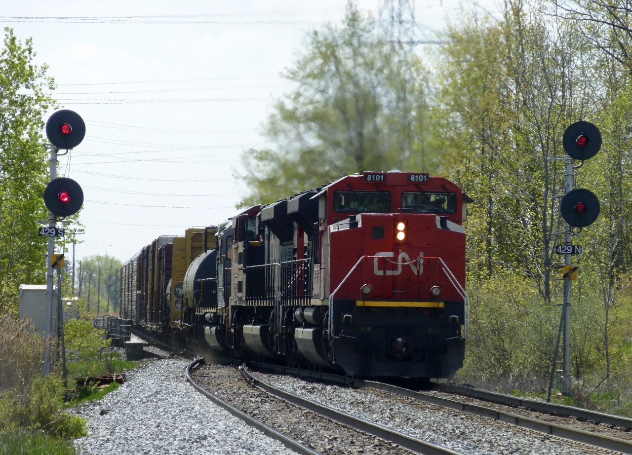 5/19/16  An eastbound to Mac Yrd train led by CN #8101 moves through the turnouts at Tansley  and onto the north track that runs between Tansley and Ash on the Halton Sub.
CN 8101 ex EMD 1208  is one of 4 SD70ACe-P6, Ex-EMDX Demonstrator units that CN purchased. 8101 is painted in CN's latest paint scheme. A far cry from the EMD silver and blue  demo colours!