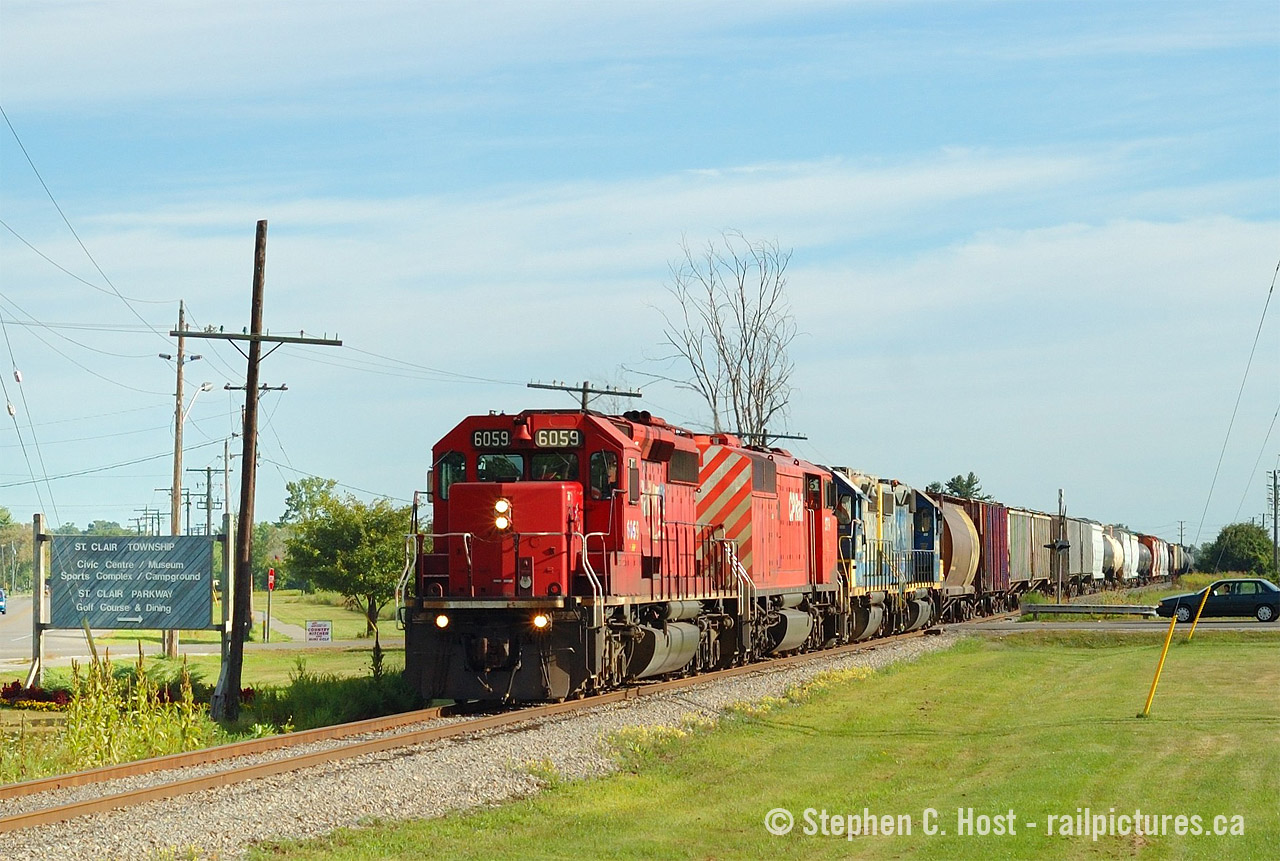 Continuing with the CSX/Chessie/C&O in Canada photos that some are posting right now, 
Here's Train D725 in the final months of operation between Sarnia and Chatham - the right of way is pristine, not a weed in sight. Big trains are operating daily on the 50 miles between Sarnia and Chatham/Blenheim, and the Rail Traffic Controller (RTC) is busy. Soon this will all change: the CSX RTC would go from handling three movements on mainline track per day each way between Blenheim and Sarnia, to basically one each way, but only operating three days a week. Imagine that, having a dispatcher basically in the chair for a Branchline, which is what this line became between 2006 and 2013. The RTC office was closed in October 2013 and the entire line became what it is now, yard limits, and operated out of town "as needed". I'm not counting the yard jobs that operated since they didn't need RTC permission - but there were 4 to 5 daily in 2005 and today, 1 to 2 daily with pretty much nothing operating on Sundays. To listen to the RTC's audio check out This link and a few more I posted here in earlier yearsNote this line is basically still mostly intact. I have heard there may be a washout south of Sombra somewhere. Anyone have any info? Also I've heard the Ridgetown station is about to be demolished. Might be some artefacts going into the dumpster..