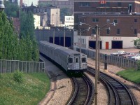 A northbound TTC Yonge line train, lead by two MLW M1 subway cars and four HSC H1 cars, heads north out of the Ellis Portal on the approach to Rosedale Subway Station. The consist is passing the back of the old Canadian Tire store along Yonge Street at Davenport, their flagship Toronto store originally constructed in 1935 and still in business today (there are proposals to redevelop the store site into high-rises, while retaining the historic front facade and a retail store somewhere inside).<br><br><i>Robert D. McMann photo, Dan Dell'Unto collection slide.</i>