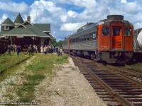 Excursionists disembark a UCRS trip at Goderich to take in the scene.  The trip had operated from Toronto via the Oakville and Dundas subdivisions to reach London, running up to <a href=https://www.railpictures.ca/?attachment_id=38375>the GMD plant for a tour.</a>  Following the tour, the trip departed London for Hyde Park, taking the Exeter Sub north to Clinton and on to Goderich.  Stratford bound, the train would <a href=https://www.railpictures.ca/?attachment_id=53560>pause at Mitchell for a runpast,</a> with another to follow <a href=https://www.railpictures.ca/?attachment_id=48021at Bright on the Drumbo Sub.</a>

<br><br><i>Original Photographer Unknown, Jacob Patterson Collection Slide.</i>