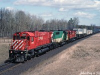 CP M-630 4565, GO Transit GP40-2 720, CP C-630M 4500 leading CP train 505 at milepost 150 Belleville sub in early May 1992. I used hang out here on Friday nights in the late eighties to late nineties to watch the action on CP and the parallel CN KIngston sub. Accessed from between the late lamented twin wooden bridges at Nichols Road, Newtonville.