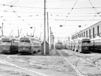 Strings of PCC streetcars sit outside the Roncesvalles car house in Toronto between 1969-1971.