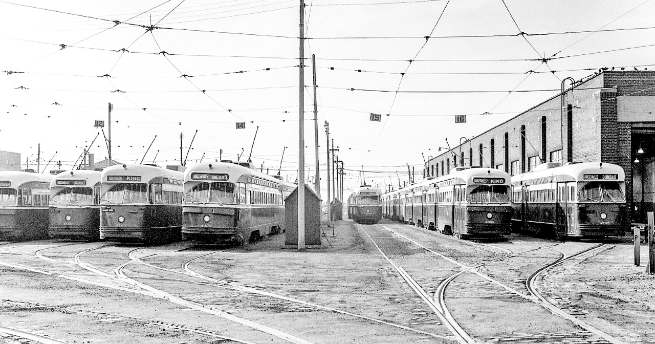Strings of PCC streetcars sit outside the Roncesvalles car house in Toronto between 1969-1971.