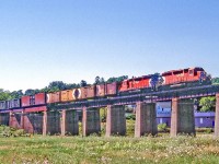 CP 5534 is on the bridge over the Ganaraska River in Port Hope, Ontario on August 6, 1987.