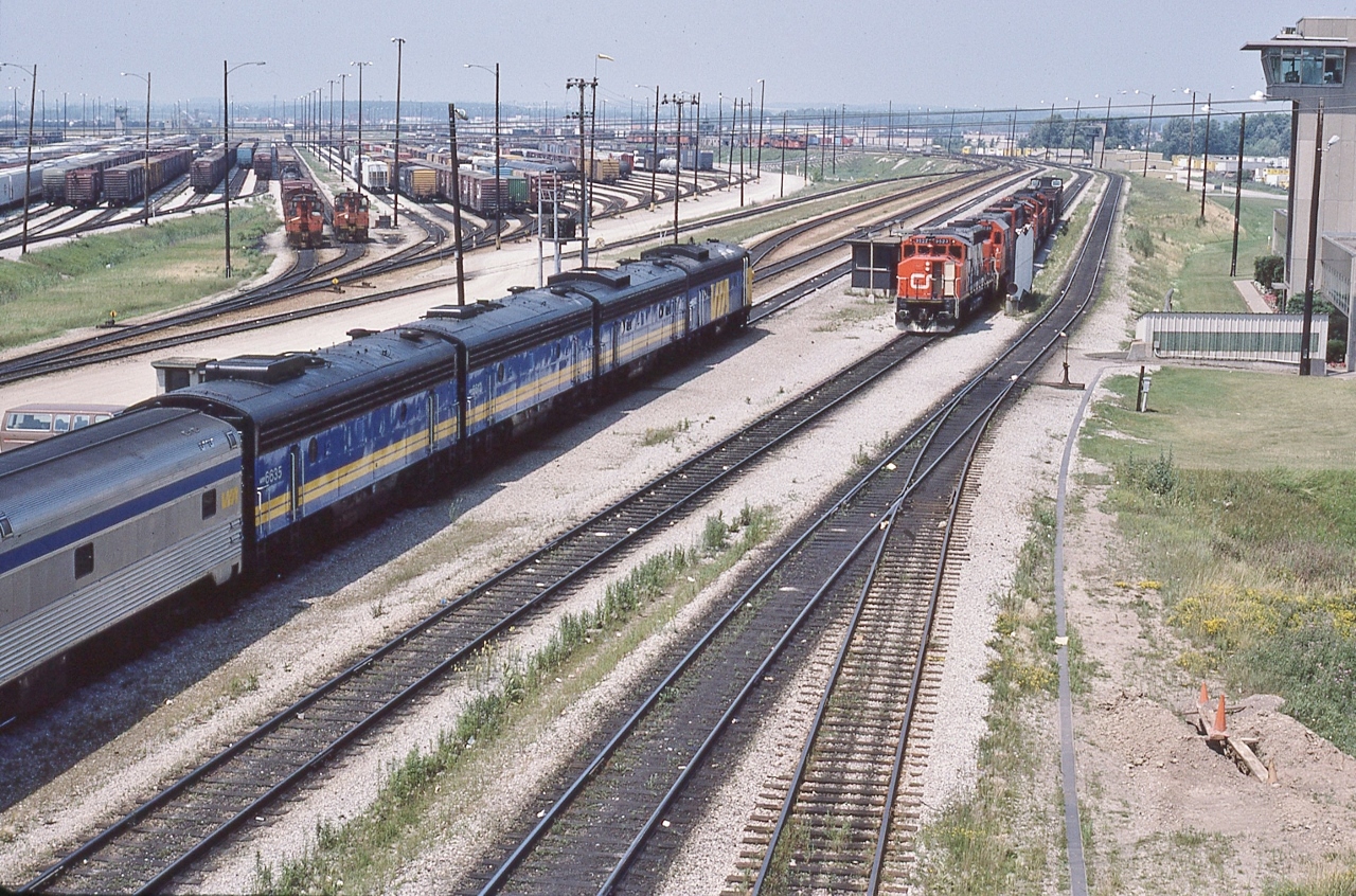 VIA #9, the Toronto section of the daily Canadian, rolls into Mac Yard,


 At Union #9's  operating crew noted a serious leak in the steam line between baggage #613  and coach #127....


 ….a routing into Mac was arranged to allow the CN pipefitters to attend to the matter.


 VIA#9 power:  6502 - 6610 - 6612 - 6635  ( FP9A – F9B – F9B – F9B )


  At right the CN lashup includes 9523 – 5039 – 95xx – 9449 – 4229 [GP40-2L(W) /  SD40 / GP40-2L(W) /  GP40-2L(W)  / GP9 ]


 at CN MacMillan Yard:  VIA #9, Toronto section  of  'Canadian' ,  July 6, 1986 Kodachrome by S.Danko


More


 another view  


Noteworthy


From CP Sudbury VIA#10 operated on the CP Parry Sound Sub to CP Reynolds, backing onto the CN at Boyne then the Bala Sub to Washago and onto the CN Newmarket arriving at Union facing East, 


 Glacier Park at CN Boyne  


VIA #9 operated north on the Bala to Doncaster onto the York Sub  to Snider, then north on the Newmarket to Washago and onto the Bala to CN  Boyne (switch points facing north) then onto the connecting track to CP Reynolds (switch points facing south) on the Parry Sound Sub.


 west on the York  


sdfourty