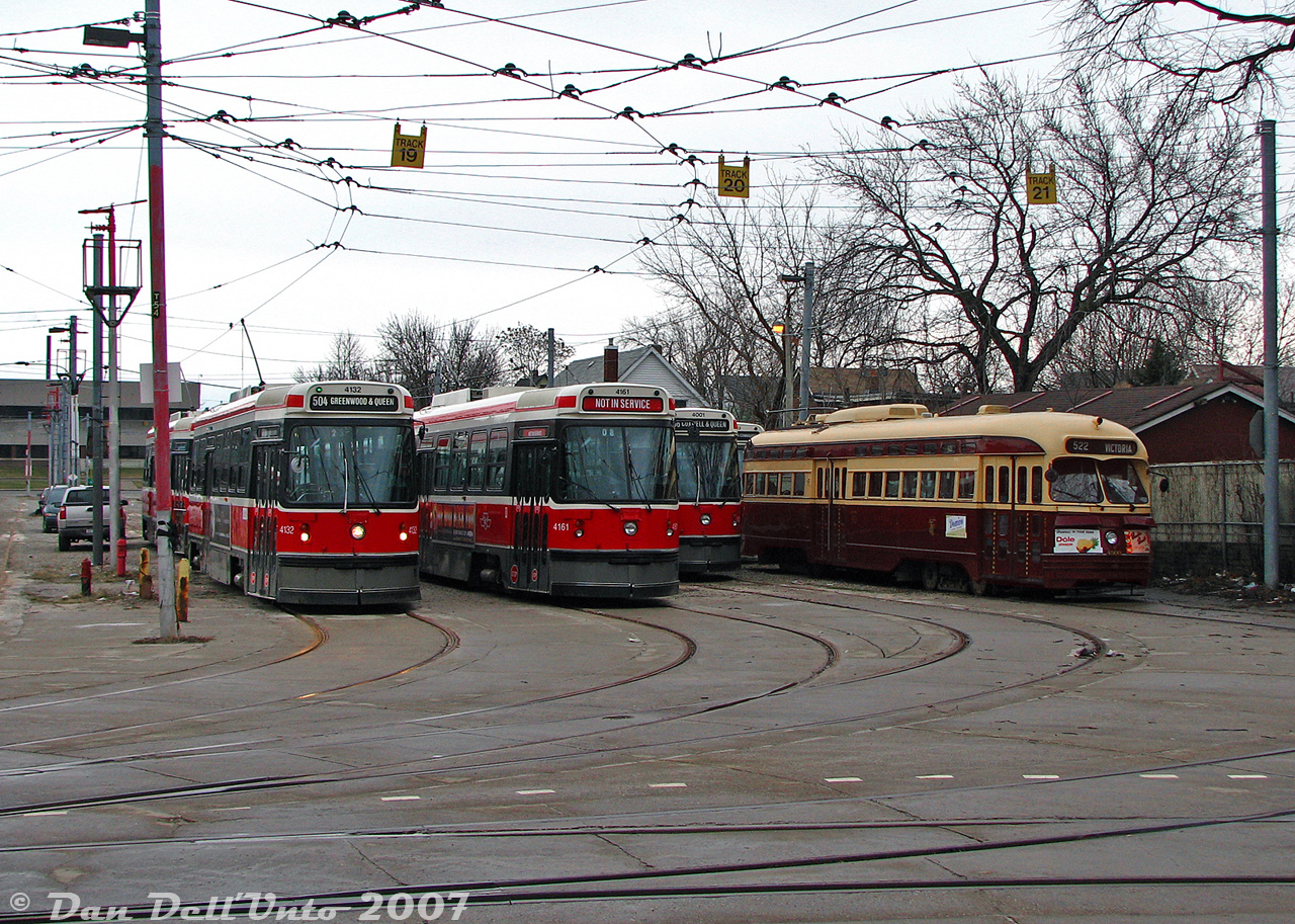 An assortment of streetcars sit in TTC's Russell Carhouse yard awaiting the call to duty...except one. TTC PCC 4500, one of two historic PCC streetcars kept by the TTC, sits on the far track in storage next to 4132, 4161, 4001 and other CLRV cars. Going into the main building and asking politely, we were escorted into the yard (private property, no trespassing!) by a kind TTC employee and allowed to take some closer and interior photos of 4500 (4549 was buried further back and not accessible for photos). 

4500 was part of the final order of new PCC streetcars built for Toronto in 1951 (A9-class 4500-4549, built by CC&F). In the late 1980's the TTC rebuilt a handful of those cars into A15-class 4600's for the new harbourfront LRT route. 4500 and 4549 were rebuilt in 1989, but retained their original numbers, were rebuilt close to their original appearance, and were repainted into their original livery. When the TTC disposed of their A15's in the mid-90's, both cars were retained for the historic fleet.Many years later, when the CLRV fleet retired in 2019, car 4001 was also kept by the TTC as part of the historic fleet.
