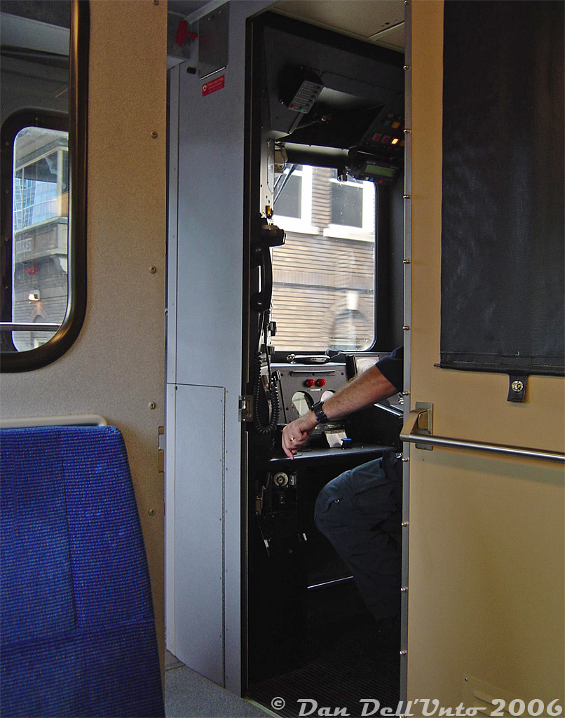 The CN engineer in charge of GO Transit cab car 242 keeps her speed down and the bell ringing as we pass by the TTR's John Street Interlocking Tower, having just departed Toronto Union Station on train #257 (one of the afternoon Toronto-Bramalea "Bramalea Flip" trains, this one departing at 11:30am off Track 1, on-time). The click-click-click of the throttle would soon bring the train up to a slightly faster departing the USRC at Strachan Ave.

Back in 2005-ish there were no new cab cars (that have an enclosed cab and no see-through windows for passengers to watch out the front), little security concerns, and the cab car door was open more often than not. It was fun sitting there looking out the front "railfan seat" window the whole trip, while glancing across and watching the speedometer hover around 80 miles-an-hour (about 130 km/h) on the stretch past Woodbine Racetrack between Etobicoke North and Malton, and after Malton on the approach to Halwest, with bell ringing for any crossings and the wind whistling through the engineers' open cab window. IIRC, the beginning of the end of the GO cab car "railfan seat" was in the late 2000's or early 2010's when GO switched to having two crewmembers in the cab, and started installing pull-down blinds on the conductor's side of the cab partition because of this.