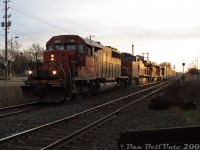 Rollin' the 40's into Brampton, elephant-style.<br><br>Back in the "Foreign Power in Ontario" (FPON) era of the 2000's, a lot of good stuff from the US showed up on CN as run-through power, but by this time most had a CN leader tacked on the head-end (due to union microwave requirements on leaders, IIRC). Sometimes it rolled through overnight, or in this case, at last light: an Extra 392 slams the CN-OBRY diamond as it eases downgrade into downtown Brampton, about to cross Mill Street on its trip to MacMillan Yard. CN SD40-2 5365 leads BNSF C44-9W 4079, BNSF SD40-2 6800 (with a massive 123" snoot nose) and IC SD40-2 6119 (CN-painted). Despite the GE, the three SD40-2's all elephant style was a nice catch (the lead '40 was originally built for Missouri Pacific, the BNSF for Santa Fe, and the IC for Burlington Northern).<br><br>Also neat in this image is the old CN-CP Brampton <a href=http://www.railpictures.ca/?attachment_id=47463><b>interchange track</b></a> switch and dwarf signal still in place on the north track. Long disused, they would finally be removed later that year in the Summer of 2007 during diamond signal upgrades by CN.