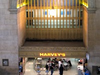 Here's a location that Steve had mentioned liking to patronize, and the "oeuf" mentioned CP crews on the downtown portlands switching job used to stop at Union to visit: the Harvey's restaurant located in Toronto Union Station's Great Hall. This photo was taken on a special GHRA private tour of John Street Roundhouse (pre-museum) and the <a href=http://www.railpictures.ca/?attachment_id=54429><b>closed-to-the-public areas</b></a> of Toronto Union Station including the vacant upper levels (before GO/Metrolinx renovated them and moved in), guided by the late Toronto railway historian Derek Boles. Note the vacant 2nd level corridor above the restaurant (used as railway office space before CN and CP moved out), and 3rd floor walkway above (just a narrow walkway with a very old glass floor, like the ones on this side above the main entrances).<br><br>The Harvey's restaurant chain was owned by Cara Operations Ltd, originally the Canadian Railway News Co. (that ran those CARA news kiosks in railway stations like Union, and later became the owner of the Swiss Chalet and Harvey's franchises). According to Derek, the Toronto Terminals Railway contracted out operations of Union Station's restaurant, lunch room and two newstands to the Canadian Railway News Co. in 1956, which some speculate may have eventually lead to this location later becoming a Harvey's. Incidentally, the location of the aforementioned restaurant was the old "Oak Room" at the west end of the west waiting wing, that was demolished for the Skywalk entrance from Union, and the lunch room was the "Maple Room" (as the York Pioneer Restaurant in the 70's) in that same area, now the site of the VIA Business Lounge. This area in the Great Hall operated as a coffee shop in the 70's before becoming a Harvey's at some point in time.<br><br>This photo may have broader appeal than just the railfan community, as it was one of those places frequented by many that was always there until it wasn't, that nobody (well, almost nobody) bothered taking a photo of to document its existence until it was too late. It was always good for grabbing a quick bite to eat with friends (as was the case on this day during lunch, with some fellow RP.ca contributors) or grabbing something to eat on the <a href=https://www.railpictures.ca/?attachment_id=59570><b>cab car ride home</b></a>. And just like that, it was closed in early 2011 during the Union Station renovations in order to replace the location with an escalator to the concourse below.<br><br>If you watch the end of "The Silver Streak" when the train was a runaway, this spot (as "The Coffee Shop", pre-Harveys) was the first restaurant location the train dispatcher ran into to look for the trainmaster. The Oak Room restaurant nearby was the second. You can also see the train crashing through the CARA news kiosk, that I remember was still at that exact same location in 2000 with the same sign, but was gone by 2005.<br><br>Other fun facts about that area of Union was the original barber shop closing in early 2012 (also due to renovations), whose barber Bruno Villanova cut hair there for nearly 51 years - he was originally hired at Union Station not long after he came off the boat from Italy in 1961! The men's washrooms right next to it were also used to film the (politically incorrect) "blackface" scenes when Gene Wilder and Richard Prior procured some shoe polish in order to get back on The Silver Streak ("What do we want with shoe polish?!" "Just pay the man!!!"). Many a happy moment was spent in there by commuters over the years, and many not-so-happy moments by overly inebriated sports fans from the Skydome waiting for their evening GO trains home.
