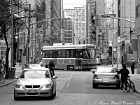 A busy street scene unfolds on the door of Ryerson University's campus: cars, pedestrians and cyclists go about their business as TTC CLRV 4005 (one of the original six prototypes built by SIG) turns westbound off Victoria Street back onto Dundas after a 505 route diversion or short turn. By this time, part of Victoria and Gould had been closed off to create a walkable campus area for students, with access remaining here for the old Ryerson parking garage that 10 Dundas East was built around.