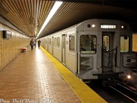 For a time, it seemed like every day was the 70's in Spadina Subway Station. The original decor with brown, red and yellow earth tones was always in abundance, and the mid-1970's-era Hawker Siddeley Canada H5 subway cars (yellow doors, musty air conditioning, buzzing chopper control sounds) were flowing through the station during rush hour like bad disco music out of some Yonge Street venue on a Friday night. One of those aging relics, TTC H5 5733 leads a northbound Yonge-University-Spadina line train out of Spadina station for Downsview.<br><br>After the <a href=http://www.railpictures.ca/?attachment_id=31197><b>H4's</b></a> went, the H5 cars were next in line to be retired by new <a href=http://www.railpictures.ca/?attachment_id=328><b>Toronto Rocket (TR)</b></a> subway trains. 5733 would be retired in November 2012 and was one of the many cars shipped to Buffalo NY for overhaul for EKO Rail in Lagos, Nigeria, but all were later scrapped when Lagos decided to purchase new cars instead.<br><br>Fun story time: some transit fans from the Toronto area were able to contact the scrapper cutting up all the H5's, rent a U-Haul truck, and drive down to Buffalo to load up on parts from the cars being scrapped, including such things as number plates, doors and seats (I think they left the musty AC condensers behind). Having some connections, I was able to obtain a pair of steel side numberboards/number plates off cars 5724 and 5771, that I noted as having rode a few times back in the day. The TTC would be able to print some good money if they sold such neat things as those on their online or pop-up merchandise store, instead of the usual trinkets and T-shirts (and the T1's are retiring soon...that's a lot of number plates!).