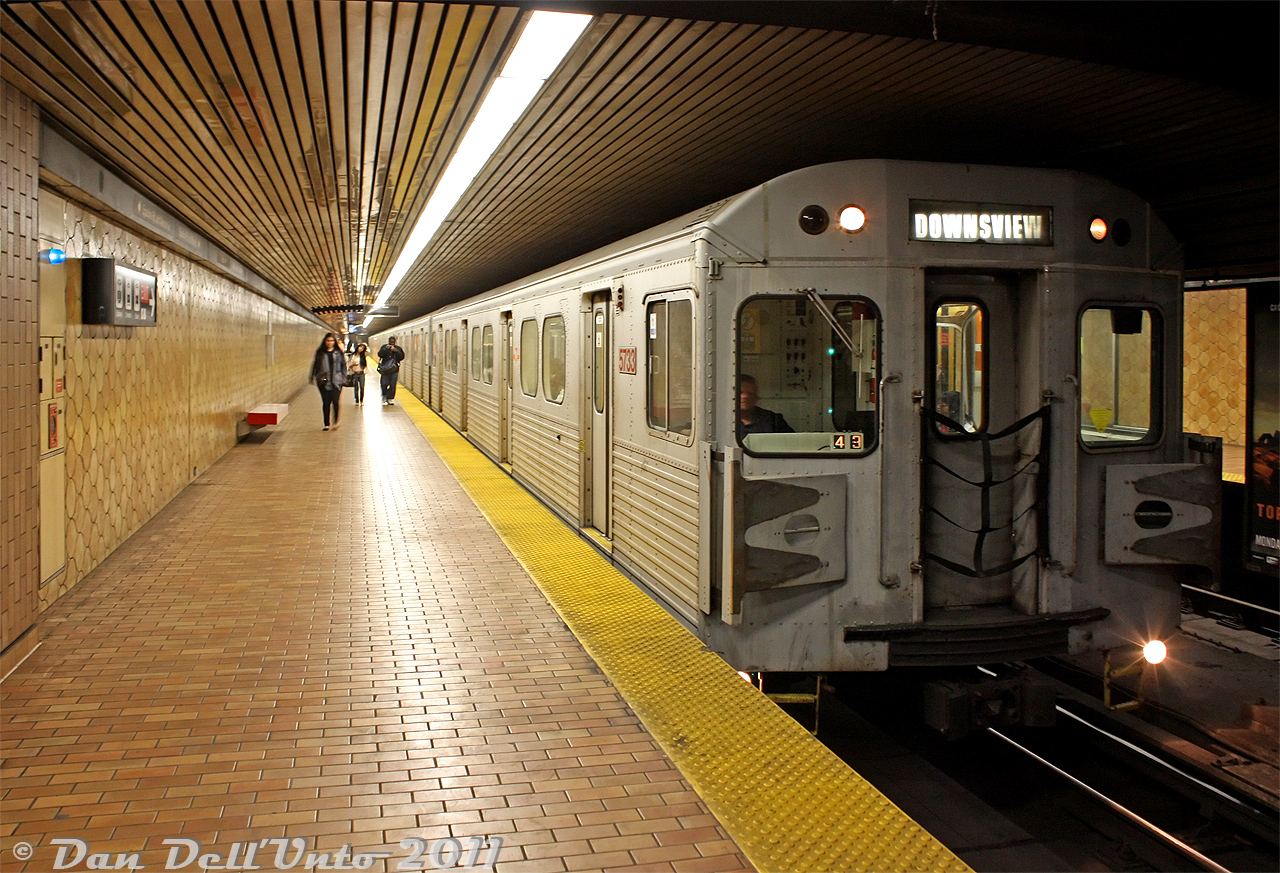 For a time, every day was the 1970's in Spadina Subway Station. The original decor with brown, red and yellow earth tones were always in abundance, and the 70's-era H5 subway trains were flowing like bad disco music out of some Yonge Street venue on a Friday night. TTC H5 5733 leads a northbound Yonge-University-Spadina line train out of Spadina for Downsview.

After the H4's, the H5 cars were next in line to be retired by new Toronto Rocket (TR) subway trains. 5733 would be retired in November 2012 and one of the cars shipped to Buffalo NY for overhaul for EKO Rail in Lagos, Nigeria, but later scrapped when they decided to purchase new cars instead.