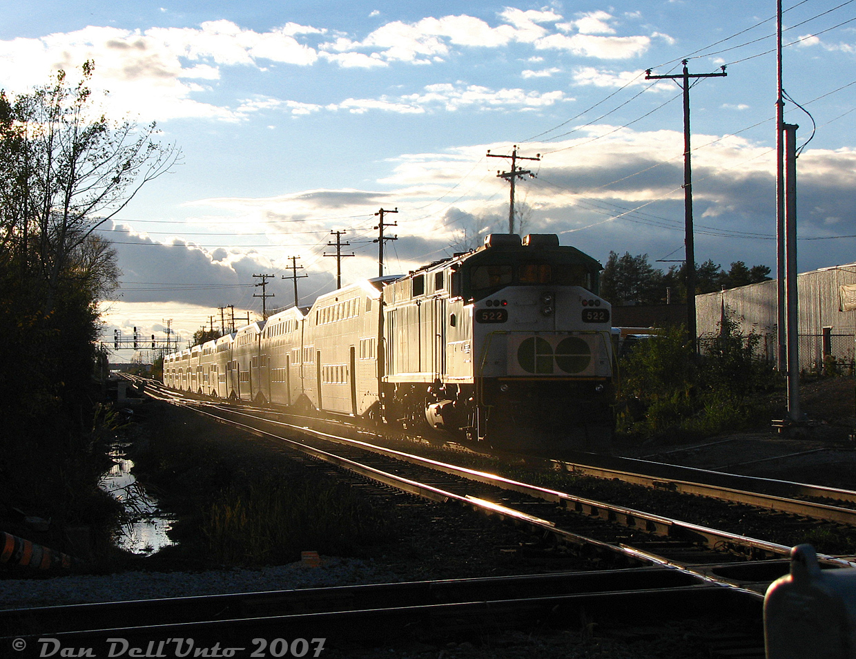 GO Transit F59PH 522 gives evening Georgetown line train #207 a big push out of downtown Brampton at sunset, clearing the CN-OBRY diamond and making the climb upgrade to Mount Pleasant GO station with cab car 240 in the lead.Back when Brampton station only had a single platform, the crossover here was regularly used by VIA trains to get to/from the north track for station stops. GO and CN rarely, if ever, used it (since Mount Pleasant also only had a north track platform at the time, all GO trains ran on the north).