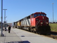 An errant passenger wanders the platform making their way to the stairs as CN #392 rolls through Bramalea GO station with some nice big power up front: CN SD60F 5558, leading "snoot-nose" UP SD40-2 3430 and IC SD40 6030. Wouldn't be CN without a striped Draper Taper leading the foreign power.
