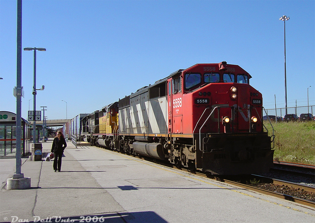 An errant passenger wanders the platform making their way to the stairs as CN #392 rolls through Bramalea GO station with some nice big power up front: CN SD60F 5558, leading "snoot-nose" UP SD40-2 3430 and IC SD40 6030. Wouldn't be CN without a striped Draper Taper leading the foreign power.