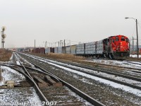 It was a cold November Saturday but there were trains to be had: CN #577, the regular CN MacMillan Yard to CP West Toronto transfer run for interchange traffic, is busy working Malport Yard with a nice combo of GP9RM 7001 and GP40-2LW 9418. On the north track of the Halton Sub, <a href=http://www.railpictures.ca/?attachment_id=9283><b>three rebuilt SD40 units</b></a> (CN 6020, 6016 & WC 6944) are working hard moving #399 past Airport Road overpass and bearing down on the crossing at CN Torbram, giving us just enough time before the bells and lights go off to cross over to the other side for a wider shot. The hum of the nearby switch heaters, offering no warmth to us, were keeping the switch for the western Brampton Intermodal Terminal lead at Torbram warm (note the small storage yard along the lead, off to the left). This was all a side-trip while waiting out the yard set with the GMD-1 inside BIT to get back to work around the Highway 7 overpass.<br><br>CN Torbram was at one point a great spot to shoot from and easily accessible from the Torbram Road grade crossing (name likely from TORonto Gore + BRAMalea), until CN turned it into an underpass during 2015-2019. Malport Yard (MALton + airPORT) was once an all-freight yard, but in recent years was closed down, most of the tracks removed, and rebuilt to handle overflow intermodal traffic from BIT (with improved security measures to keep photographers away).<br><br>At the time local job #578 was based out of Malport (4102 & 4135 in the yard on this day), which switched the Bramalea area industries including the Torbram Industrial Lead, and I think also for a #579 that switched the Weston Sub at night, with #577 dropping and lifting traffic for both from Mac Yard. Then there was <a href=http://www.railpictures.ca/?attachment_id=4751><b>CN #559</b></a> from MacMillan Yard that handled the Brampton customers and as far west as the Dixie Cup Spur (that may have been covered by #578 before, the specifics are a bit hazy).