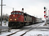 CN's Draper Taper cowl units looked sort of weird leading freight trains solo, almost as if there should be some Budd or LRC passenger cars trailing behind instead of freight cars, and everything lettered "VIA Rail" (I'm sure that exists on someone's layout).<br><br>CN SD60F 5546 pulling a "One-Unit Wonder" leads a short eastbound freight (possibly #330) into downtown Brampton, its head-end splitting the signals at Mill Street crossing as the rest of the train thumps the Brampton diamond. Compare this scene to an <a href=https://www.railpictures.ca/?attachment_id=59533><b>earlier photo that year</b></a>: note the new signals here and in the distance (installed during the summer as part of an upgrade by CN), and the removal of the old CN-CP interchange track switch and dwarf signal off the north track.