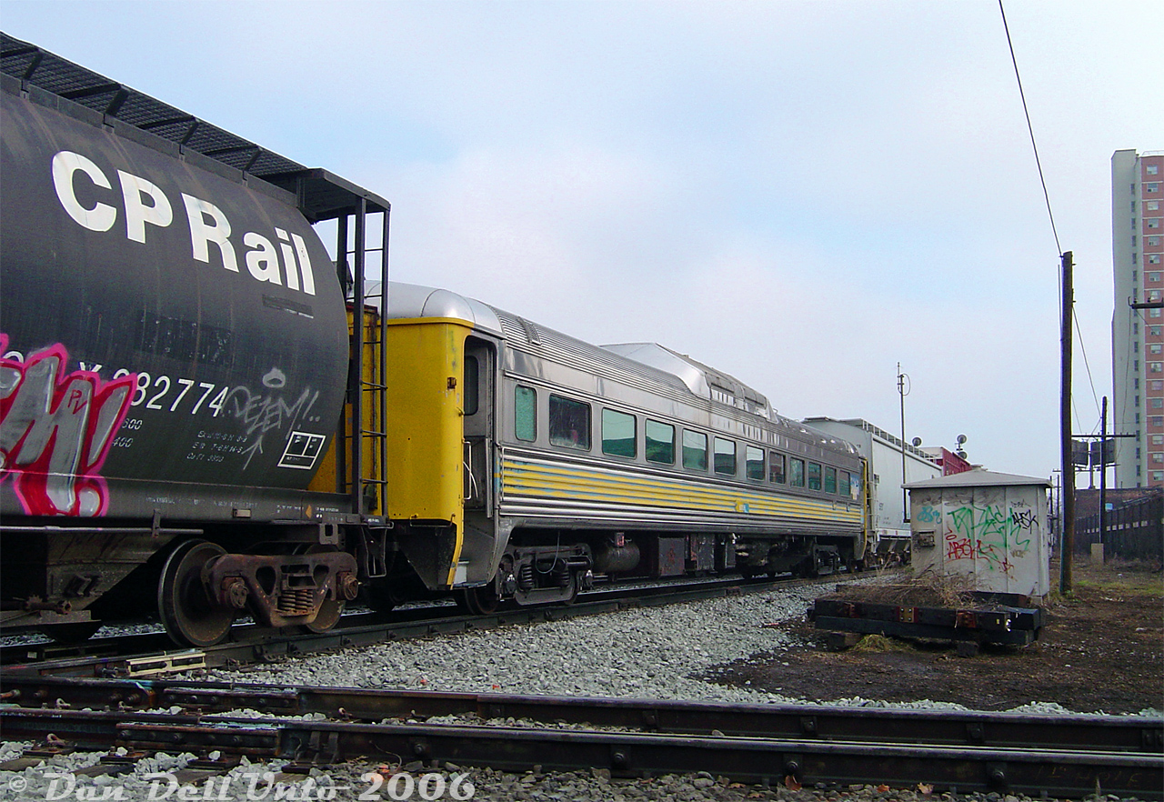 Seeing some recent photos posted of Waterloo Central's RDC-9 (WCR 6006) in service reminded me of an earlier encounter with the same car:Wandering around CP's North Toronto Sub with a friend, the usual CP #T56 transfer to West Toronto put in an appearance at Davenport Diamond. By surprise, it had this random ex-VIA RDC-9 buried in its train, DAWX 6006, which we later found out was heading to the Orangeville-Brampton Railway. It's pictured just about to slam the Davenport Diamond with CN's Newmarket Sub, marshalled between two hoppers for forwarding.The origins of this car can be traced to the Boston & Maine Railroad, the only owner of the RDC-9 model (30 cars were built by Budd for the B&M in 1956 as full coaches, with no end cabs or controls, and only one engine - essentially a trail-only RDC). Numbered 6925, it and six other RDC-9 cars were sold to Canadian National in 1965 (as CN D506/6006), changing hands to VIA Rail in the late 70's. It continued in service into the mid-1980's before being retired and later sold to a Quebec area railway equipment dealer (the ownership details are a bit mirky, but they eventually came under ownership of dealer David A. Walmseley (DAWX)). Most of the cars were dispersed years later, and 6006 went to OBRY in Orangeville to join the small collection of passenger cars on the Credit Valley Explorer. It was put into service as a non-powered coach a number of years after sitting stored in Orangeville. When the CVE disbanded at the end of Cando Contracting operations on the OBRY, the passenger cars were sold off. 6006 and some other cars were all sold to the Waterloo Central Railway.