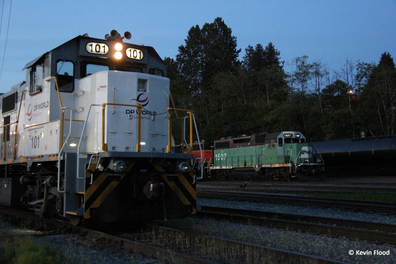 At dusk, a local BNSF switching job with BNSF 1507-BNSF 2536 is about to wrap up for the evening at Brownsville Yard. Meanwhile, in the foreground, a DP World Logistics switching unit switches container flats.