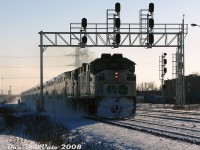 Working the weekend shift on a frigid winter's day, double GO Transit F59PH's 528 and 543 charge through Burlington West with Lakeshore line train #924 at last light, kicking up a trail of snow as they bear down on their next stop at Burlington GO Station.<br><br>I was told at the time by a source that the twin F59's assigned to many weekend Lakeshore lines trains were not because of reliability issues, but for better acceleration and weekend schedule adherence (6000 horsepower does get the train moving faster than 3000 horsepower). New MP40 units operated in consists like this with an F59PH trailing, but for their break-in period before they were released to operate solo. Some of those LL10 (or 2L10) consists would stay together and operate during the weekdays.<br><br>528 would get sold to Trinity Railway Express the next year (and not have to deal with a Canadian winter again), while 543 was sold to AMT in 2011 (only to be later bought back by GO as 582).