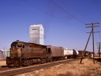 Timetable train No. 83 was a wayfreight between Medicine Hat and Lethbridge, shown here arriving near the east end of Lethbridge at 1430 MDT on Thursday 1974-10-03 when the line still ran through downtown.  I have seen many filthy locomotives, and C-424 CP 4204 certainly deserves a prize — imagine the river of muddy water resulting when it finally was washed!