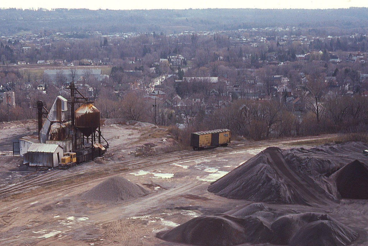 Here's a view looking down from the CCSL (Canada Crushed Stone Ltd)  conveyor building (before it was demolished in 1986) and shows the old Steetley Quarry operations off the south side of the CN Dundas sub at mile 4. What is interesting in this photo is the operation had access to the CN on the left, as well the old Dundas Branch (H&D) of the TH&B which I recall running along Hatt St in the downtown.
Never was able to catch a TH&B move this far on the line. Best I could do was a lonely old TH&B boxcar shown. It is interesting there was actually a connection between CN and the TH&B in Dundas, if only thru some industrial trackage.
All this is gone. A modern subdivision of pricy homes has taken its place.