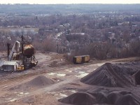 Here's a view looking down from the CCSL (Canada Crushed Stone Ltd)  conveyor building (before it was demolished in 1986) and shows the old Steetley Quarry operations off the south side of the CN Dundas sub at mile 4. What is interesting in this photo is the operation had access to the CN on the left, as well the old Dundas Branch (H&D) of the TH&B which I recall running along Hatt St in the downtown.
Never was able to catch a TH&B move this far on the line. Best I could do was a lonely old TH&B boxcar shown. It is interesting there was actually a connection between CN and the TH&B in Dundas, if only thru some industrial trackage.
All this is gone. A modern subdivision of pricy homes has taken its place.
