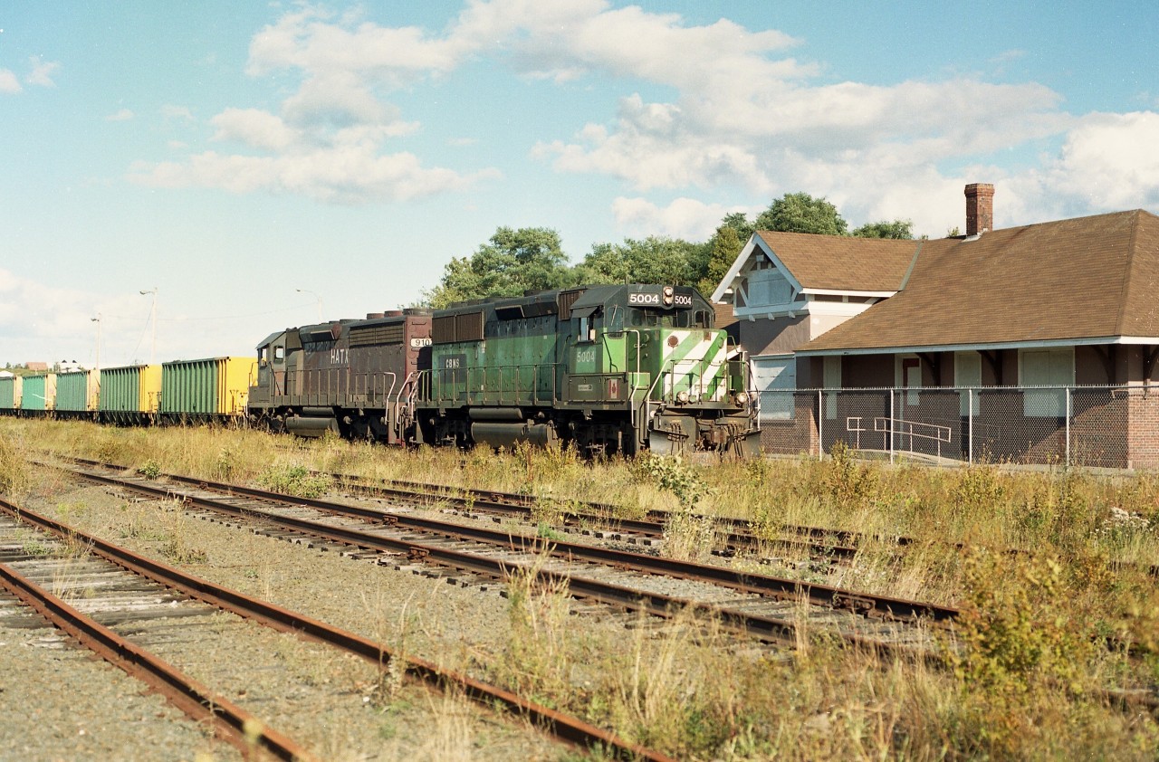 The Mamiya 645 film camera has caught CBNS 5004 and HATX 910 bringing a coal train from Sydney Mines on this beautiful late summer afternoon. I have to admit luck was riding with me, as I had just showed up to grab a photo of the now closed (1990) North Sydney station when I heard a horn not too far off. What are the odds? At the time I had no idea that Sydney Mines was going to shut down in a scant two months and business would quickly  wind down. After the closure, all activity along the line pretty much petered out and even with support from the province the CBNS finally threw in the towel, running the last train out of Sydney at the end of 2014. This marked the end of 135 years of railroad activity serving the Sydney area. The only activity now for CBNS in Cape Breton is at Port Tupper and Port Hawkesbury down on the south end by the Strait of Canso.
However the rusted tracks are still in place, and with tracks there is always hope, faint as it may be.