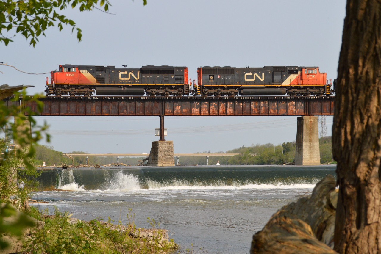 Hanging around catching the morning trains over the Caledonia bridge is an entertaining experience, up to a point. When I saw what I consider "the same old" coming out onto the bridge, I elected to go artsy-fartsy.
Something different. I guess it's okay.  CN 8958 and 5712 heading to Garnet from Sarnia.