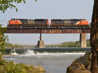 Hanging around catching the morning trains over the Caledonia bridge is an entertaining experience, up to a point. When I saw what I consider "the same old" coming out onto the bridge, I elected to go artsy-fartsy.
Something different. I guess it's okay.  CN 8958 and 5712 heading to Garnet from Sarnia.