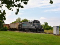 When wandering out to St. Thomas (for lunch) and back, I usually do not see much of anything. It was a surprise to hear a horn in the distance as I left the restaurant, and got ahead of this eastbound train at New Sarum, as it came up to Belmont Rd (Hwy 74). The former GTW GP9R is now in GIO dress, as I suppose most fans around Southern Ontario know.
The line is the St. Thomas, Alymer and Tillsonburg Rwy, a division of GIO. Image taken at mile 113.56, Cayuga Spur. (so reads the info on the silver box!)