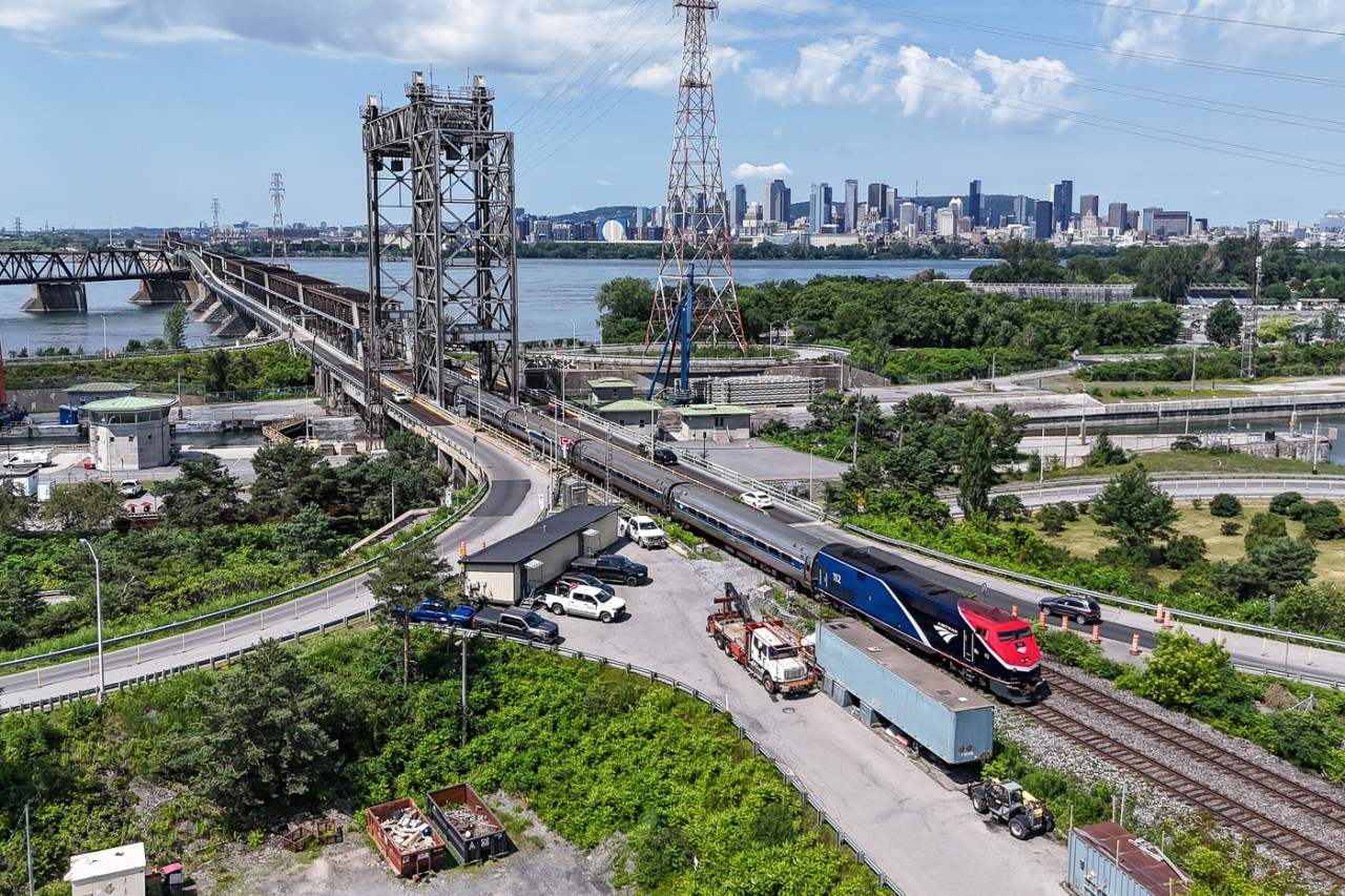 Amtrak's Montreal to New York train #68 leaves the Montreal skyline behind as it exits the Victoria bridge across the St Lawrence River.