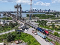 Amtrak's Montreal to New York train #68 leaves the Montreal skyline behind as it exits the Victoria bridge across the St Lawrence River.