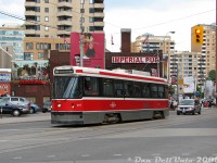 Another one for the Ryerson students: TTC CLRV 4117 heads west on Dundas Street crossing Victoria, within a stone's throw of Yonge Street, Dundas Square and the Ryerson University campus. Just behind the streetcar is the side of the famed Imperial Pub, long one of the local university watering holes. One thing I never noticed before is the Imperial's rooftop patio to the left of the front windshield, an ideal vantage point to take in the happenings around Dundas Square while enjoying a pint.<br><br>Visible above the patio is the newer student residence building at Dundas & Bond (built on the old Evangelical Temple church site, I've got a slide somewhere...). On the upper left is the old <a href=http://www.railpictures.ca/?attachment_id=31608><b>Simpsons-Sears catalogue warehouse building</b></a> (now lofts). Some newer highrises along Church can be seen in the distance, along with the edge of the Bond Place Hotel on the right. One of those silly but colourful Koodoo ads and a selection of 2000's autos rounds things out (anyone nostalgic about a Grand Caravan yet?). There's been a few changes compared to Bill Hood's similar 1982 photo <a href=https://www.railpictures.ca/?attachment_id=59087><b>here</b></a>).<br><br>Photos show we were making our way to that horrible pizza place nearby (the one with two pizzas in its name) at Church for lunch after class, then a trip straight to Mimico via the subway to <a href=https://www.railpictures.ca/?attachment_id=59109><b>feast on surplus F59's</br></a>.