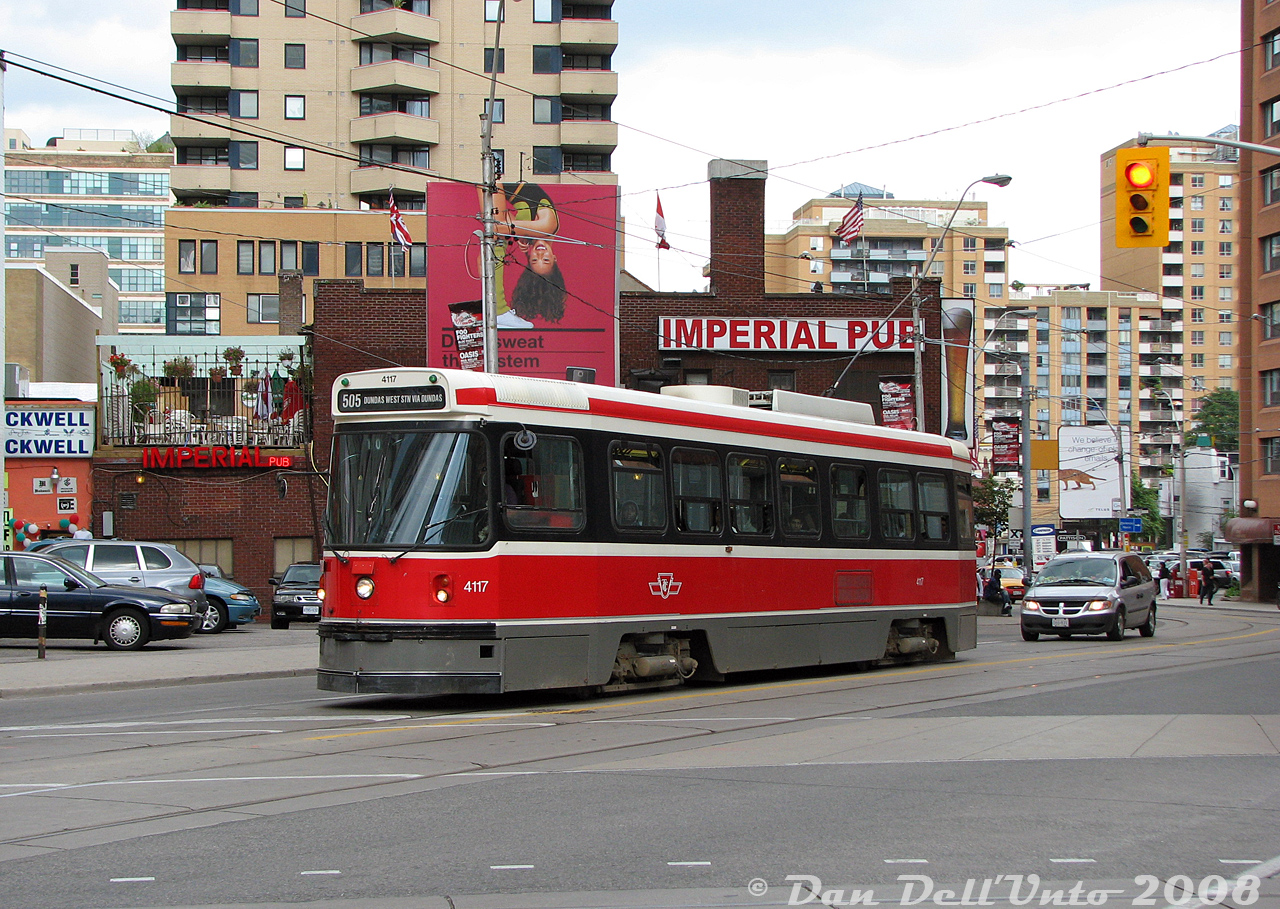 Another one for the Ryerson students: TTC CLRV 4117 heads west on Dundas Street crossing Victoria, within a stone's throw of Yonge Street, Dundas Square and the Ryerson University campus. Just behind the streetcar is the side of the famed Imperial Pub, long one of the local university watering holes. One thing I never noticed before is the Imperial's rooftop patio to the left of the front windshield, an ideal vantage point to take in the happenings around Dundas Square while enjoying a pint.

Visible above the patio is the newer student residence building at Dundas & Bond (built on the old Evangelical Temple church site, I've got a slide somewhere...). On the upper left is the old Simpsons-Sears catalogue warehouse building (now lofts). Some newer highrises along Church can be seen in the distance, along with the edge of the Bond Place Hotel on the right. There's a few changes compared to Bill Hood's similar 1982 photo here).

Photos show we were making our way to that horrible pizza place nearby (the one with two pizzas in its name) at Church for lunch after class, then a trip straight to Mimico via the subway to feast on surplus F59's.