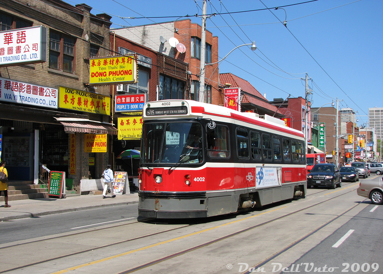 There's no mistaking the Chinatown area of Toronto: TTC CLRV 4002 (one of the original SIG prototype cars) heads westbound on Dundas Street between Huron and Spadina, passing the various Chinese businesses and shops that line this part of Dundas.