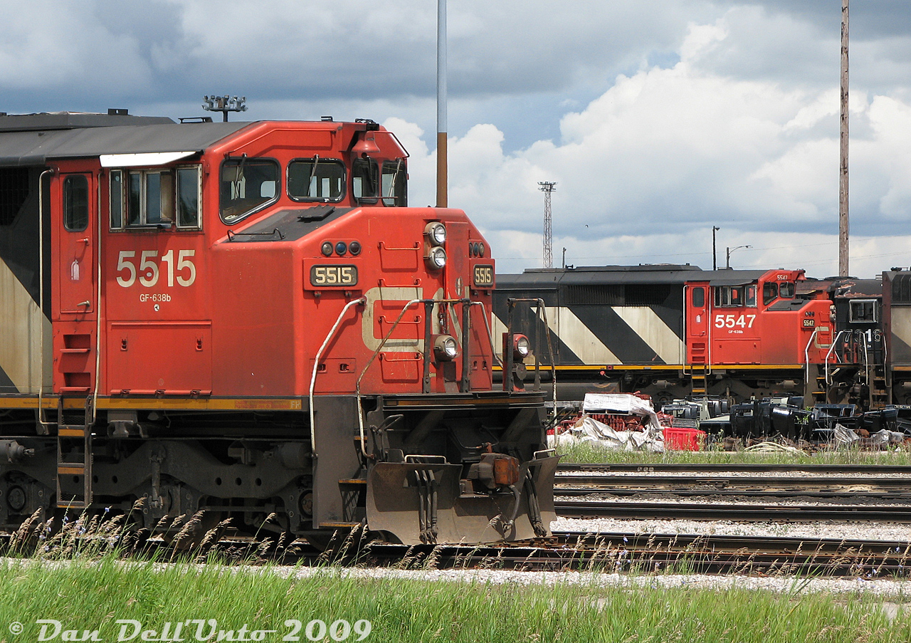 CN SD60F units 5515 and 5547 graze on the shops tracks around CN's MacMillan Yard diesel shop, part of a variety of stored 4- and 6-axle mainline power due to a traffic downturn at the time, including SD50F's, SD60F's, GP40-2LW's, and SD40-2W's and C40-8M's. They would all be reactivated and put back to work later when things picked up.