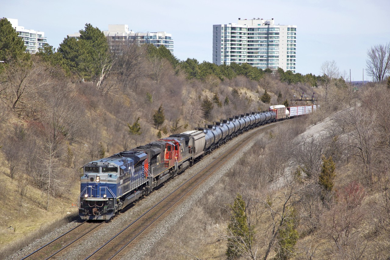 What I believe to be either M314 or M305 heads westbound uphill past Hilda Ave in Thornhill on a sunny afternoon back in the Spring of 2014. Leading the freight is a former EMDX SD70ACe painted up in the blue and navy demonstrator scheme...now under the ownership of CN. I recall CN picked these up after leasing them either in early 2014 or late 2013...not sure on the exact date.