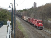 An eastbound CWR work train loaded with ribbon rail cruises eastbound through the neighbourhood. Not sure if this was a work train for the Galt, Mactier, or Belleville Subs. Big points for the cylindrical hoppers for buffers. This consist had a work van on the tail end to boot. 